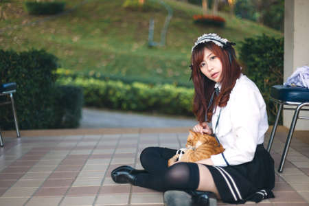 Charming Asian girl in japanese maid costume in film color styleの写真素材