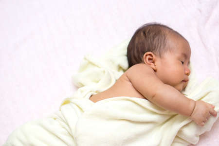 Asian baby was covered in  towel