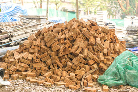 Pile of red bricks in construction siteの写真素材