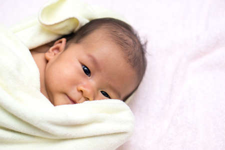 Asian baby was covered in  towelの写真素材