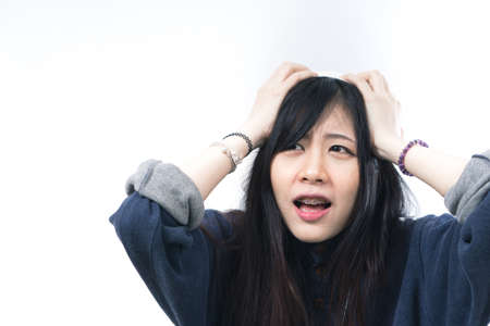 Asian woman thinking on white backgroundの写真素材