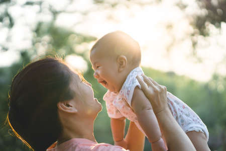 Asian mother playing with her sonの写真素材