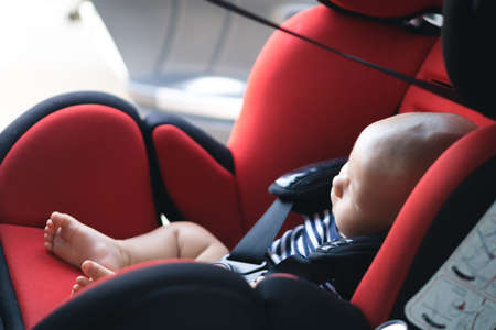 Asian baby sleeping in carseatの写真素材