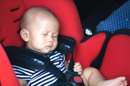 Asian baby sleeping in carseatの写真素材