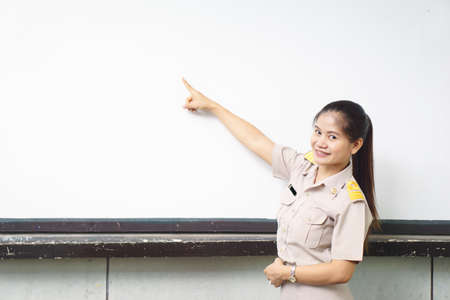 Thai teachers in official uniform point to white board