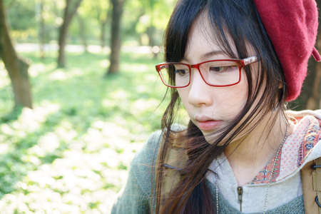 Charming Asian girl in the parkの写真素材