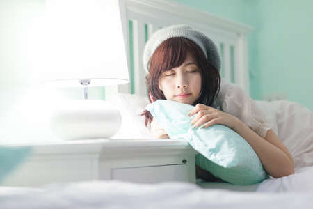 Charming Asian girl wearing pajamas on the bed