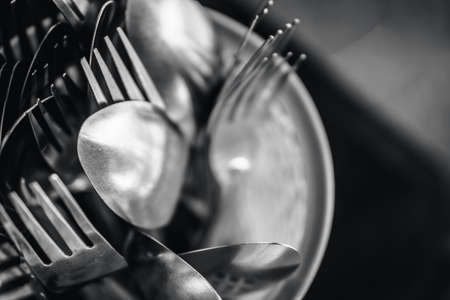 Fork and spoon in plastic container found in street stallの写真素材