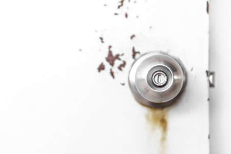 Door knob on rusty doorの写真素材