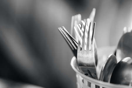 Fork and spoon in plastic container found in street stallの写真素材