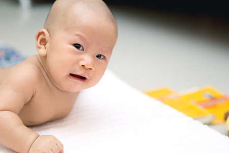 Portrait of a crying Asian babyの写真素材
