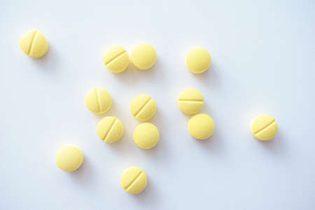 Yellow pills isolated on white background