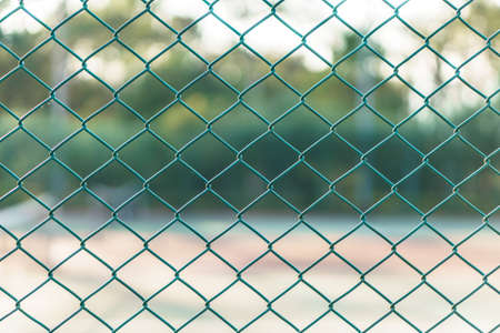 Green wire mesh steel at tennis courtの写真素材