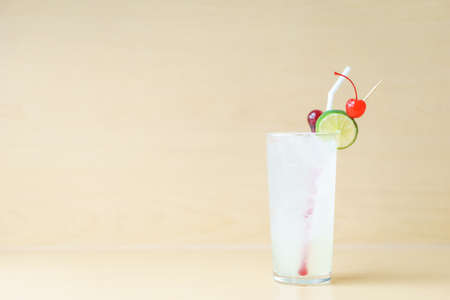 Gin fizz cocktail on wooden background