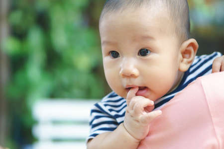Asian mother and son on her shoulderの写真素材