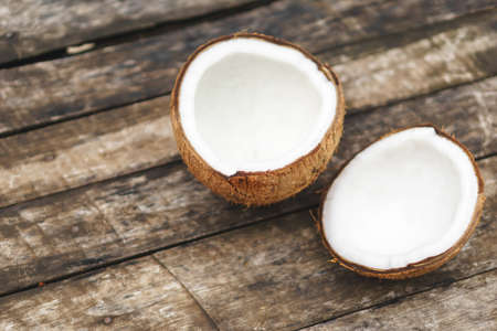 coconut with shell on wooden backgroundの写真素材