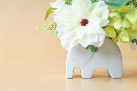 Artificial flower on modern elephant potの写真素材