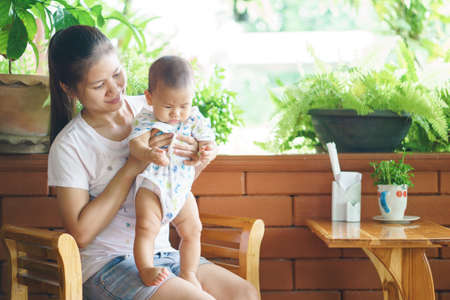 Asian mother holding her son