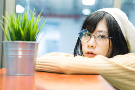 Charming Asian girl with a green plant potの写真素材