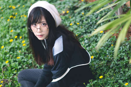 Portrait of charming Asian girl in the parkの写真素材