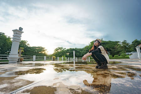 Charming Asian girl in hip hop style with sunset as background