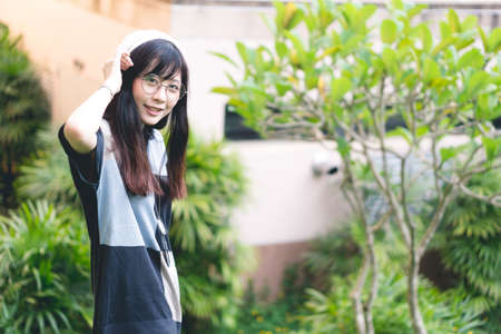 Portrait of charming Asian girl in the parkの写真素材