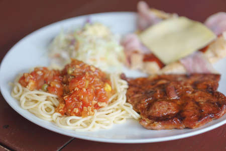Dish of chicken spaghetti with pork steakの写真素材