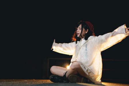 Night portrait of charming Asian girl at nightの写真素材