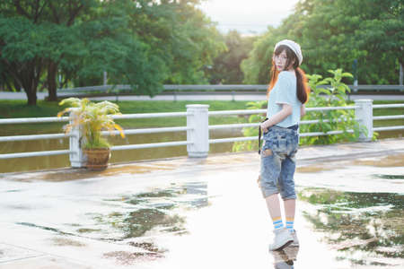 Charming Asian girl wearing jean overallsの写真素材
