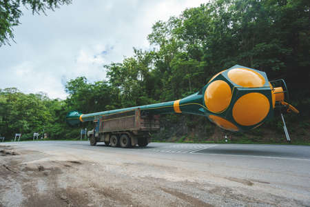 Old truck carrying oversize water tankの写真素材
