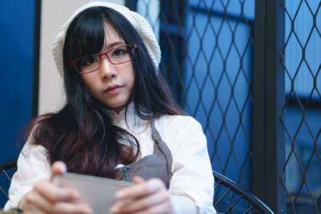 Charming Asian girl in casual wear taking selfie photoの写真素材