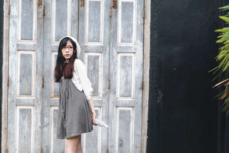 Charming Asian girl with umbrella in raining day