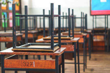 Wooden Thai school chairs on the desk at the end of the dayのeditorial素材