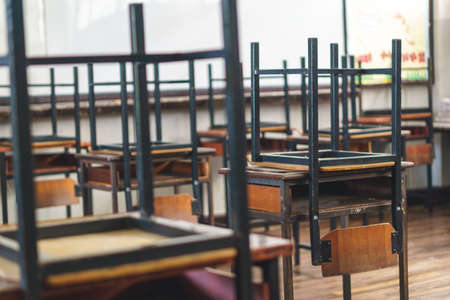 Wooden Thai school chairs on the desk at the end of the dayのeditorial素材