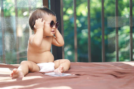 Asian baby wearing round classic glassesの写真素材