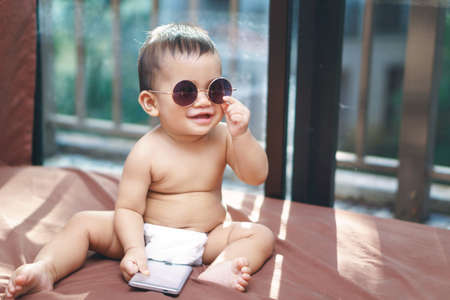 Asian baby wearing round classic glassesの写真素材