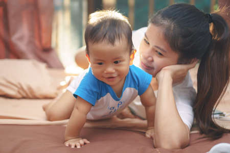 Asian mother playing with her sonの写真素材