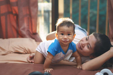 Asian mother playing with her sonの写真素材