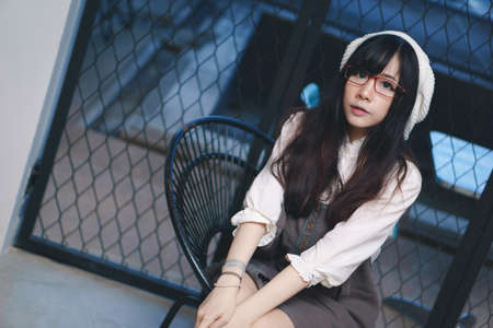 Portrait of charming Asian girl in a coffee shop