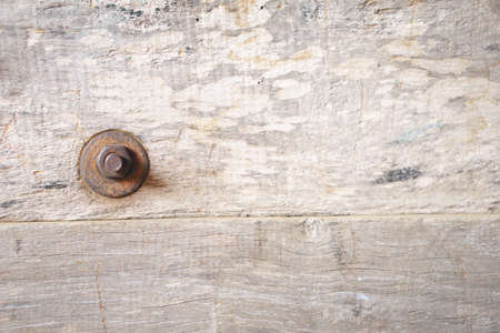 Old weathered log wall texture with rusty screwの写真素材