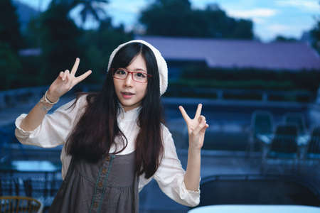 Portrait of charming Asian girl in a coffee shopの写真素材