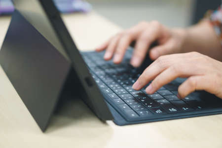 Asian woman hands using tablet with Thai language keyboardの写真素材