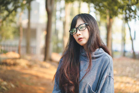Portrait of charming Asian girl in the park before sunsetの写真素材