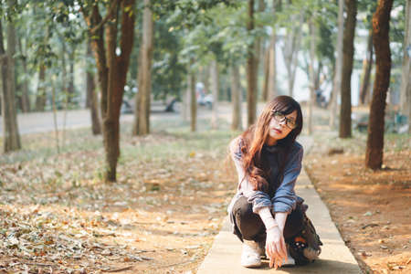 Portrait of charming Asian girl in the park before sunsetの写真素材
