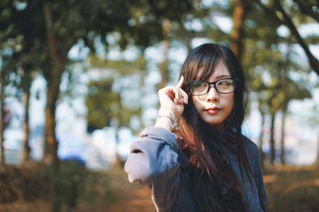 Portrait of charming Asian girl in the park before sunsetの写真素材