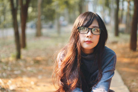 Portrait of charming Asian girl in the park before sunsetの写真素材