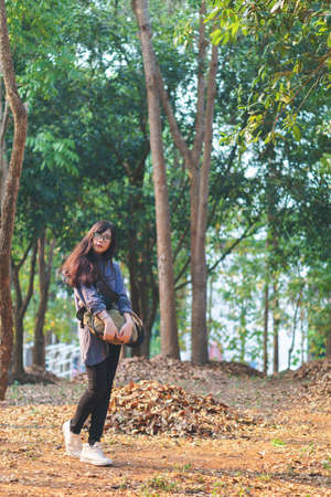 Portrait of charming Asian girl in the park before sunsetの写真素材