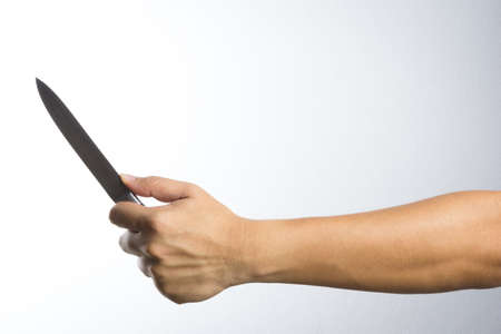 A hand holding knife on white backgroundの写真素材