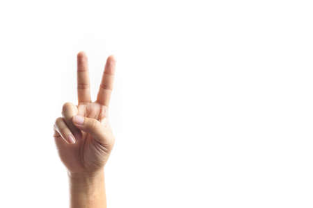 A Hand showing victory sign on white backgroundの写真素材