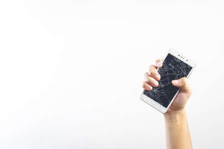 Man hand holding mobile phone with broken screenの写真素材
